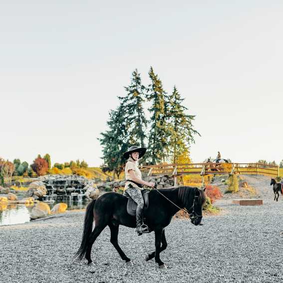 MHC woman riding black horse on IMTCA trail course